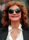 <p>Sarandon is one shady lady at Cannes. The legendary actress kept her eyes covered but allowed her copper waves to flow in the wind, with her tresses working perfectly with her red lipstick. (Photo: Getty Images) </p>