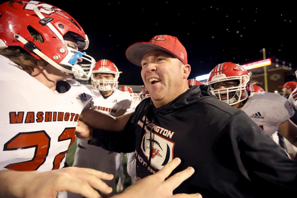 Washington's head football coach Brad Beller celebrates with players during the Class 2A high school football championship game between Millwood and Washington at Chad Richison Stadium in Edmond, Okla., Saturday, Dec. 9, 2023.