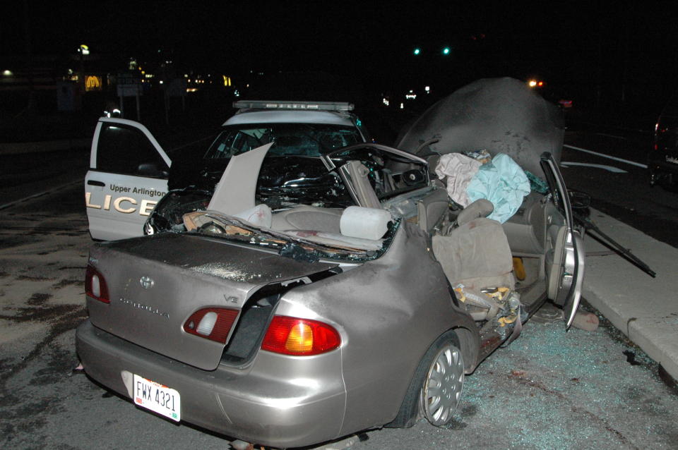 This photo provided by the Columbus Police shows an accident involving a police cruiser and a stopped car on Oct. 18, 2013. An Ohio police officer whose cruiser slammed into a stopped car in the middle of an intersection tried to veer away but couldn't avoid the crash that killed six members of a family, and there is no basis to charge him, authorities announced Thursday, Feb. 20, 2014. Investigators concluded that the other driver entered a Columbus-area intersection despite a red light and was struck on the side by an Upper Arlington police cruiser that was responding to a middle-of-the-night robbery call with its lights and sirens activated. The Oct. 18 crash killed the driver, his wife and four of their daughters, and the police officer was seriously hurt. (AP Photo/Columbus Police)