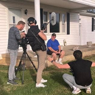 George Gillilan, seated, is interviewed at his Pomeroy, Ohio, home by a Dutch film crew who had purchased and returned his uncle's Purple Heart and other effects after finding them posted on the Internet.