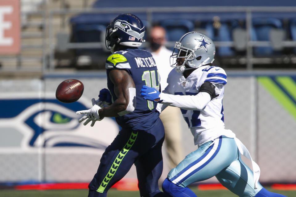 Sep 27, 2020; Seattle, Washington, USA; Dallas Cowboys cornerback Trevon Diggs (27) forces a fumble by Seattle Seahawks wide receiver DK Metcalf (14) during the first quarter at CenturyLink Field. Mandatory Credit: Joe Nicholson-USA TODAY Sports