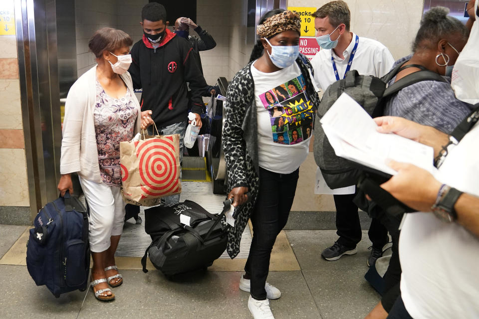 Passengers on a train from Florida mostly ignore workers at Penn Station during an effort to screen out-of-state travellers and enforce the state's 14-day coronavirus disease (COVID-19) quarantine in the Manhattan borough of New York City, New York, U.S., August 6, 2020. REUTERS/Carlo Allegri