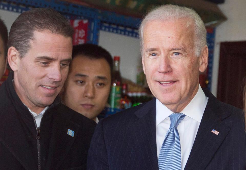 Then US Vice President Joe Biden (R) tours a Hutong alley with his son Hunter Biden (L) in Beijing, China, 05 December 2013.