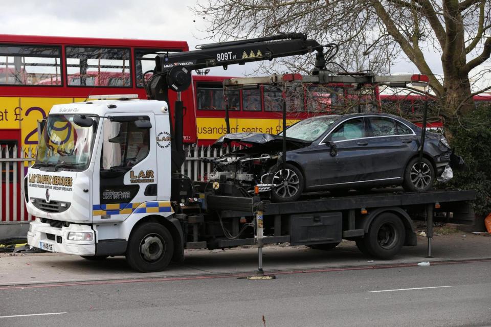 Removal: The wrecked Mercedes being taken away (PA)