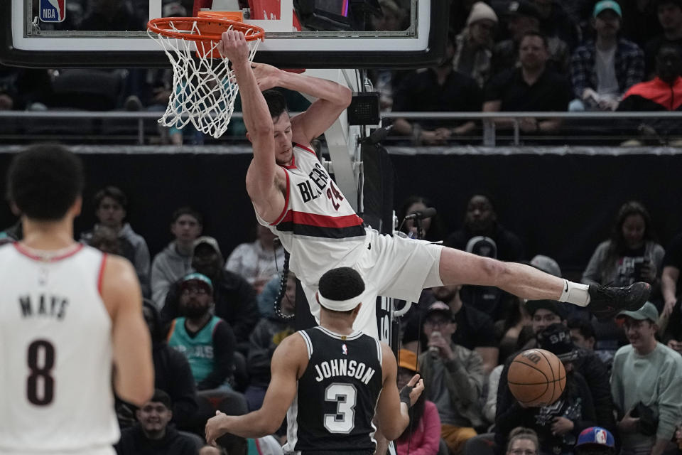 Portland Trail Blazers forward Drew Eubanks (24) scores over San Antonio Spurs forward Keldon Johnson (3) during the second half of an NBA basketball game in Austin, Texas, Thursday, April 6, 2023. (AP Photo/Eric Gay)