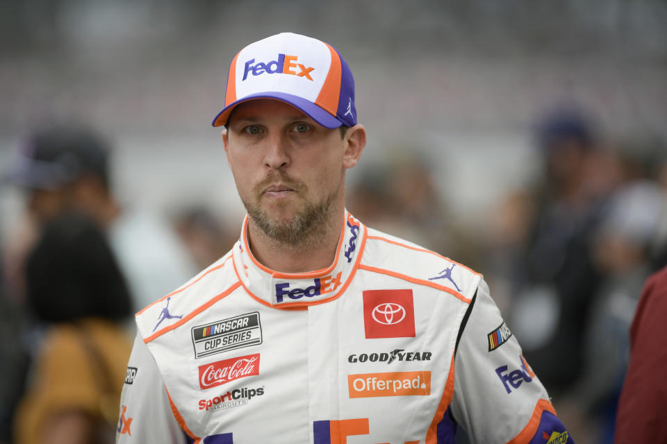 FILE - Denny Hamlin makes his way to his car for a NASCAR Cup series auto race in Talladega, Ala., Sunday, Oct. 3, 2021. The race was postponed due to weather. Long recognized alongside Mark Martin as the greatest NASCAR driver to never win a championship, Hamlin has a fifth try Sunday to at long last grab that elusive Cup title. (AP Photo/John Amis, File)