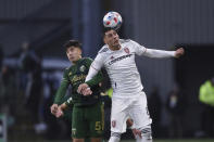 Portland Timbers defender Claudio Bravo (5) and Real Salt Lake midfielder Damir Kreilach (8) jump up for a head ball during the first half of the MLS soccer Western Conference final Saturday, Dec. 4, 2021, in Portland, Ore. (AP Photo/Amanda Loman)