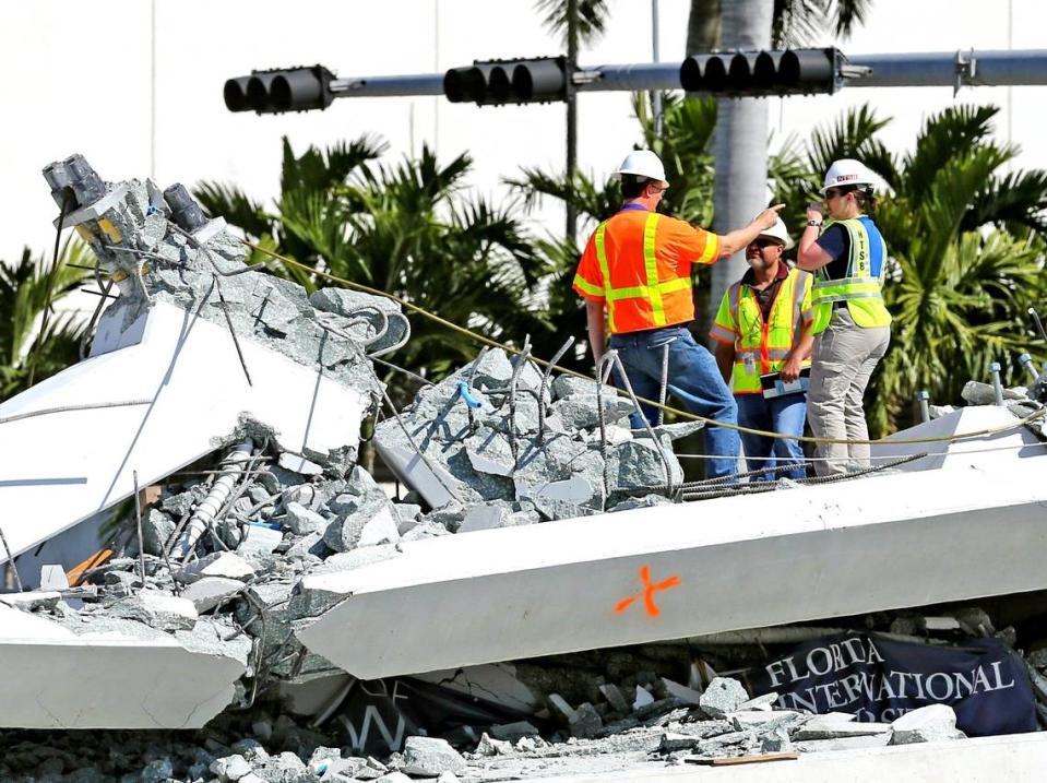 On March 16, 2018, National Transportation Safety Board inspectors stand along a section of the FIU bridge at Southwest Eighth Street and 109th Avenue. The bridge collapsed the day before, on March 15, killing six people.