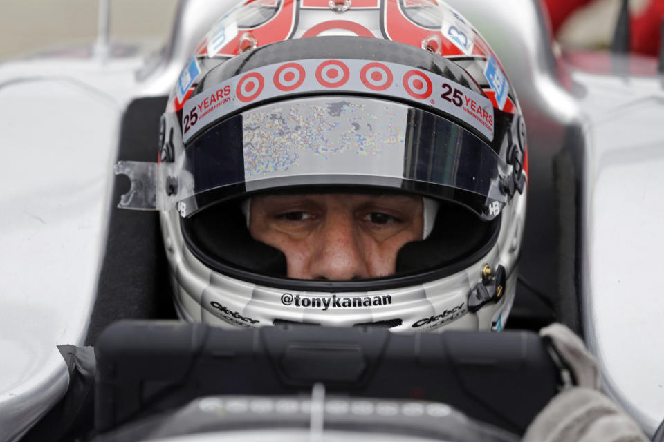 FILE - In this May 14, 2014, file photo, Tony Kanaan of Brazil, checks racing data as he waits in the pits during practice for the Indianapolis 500 IndyCar auto race at the Indianapolis Motor Speedway in Indianapolis. Kanaan will get to race 5 oval events, including the Indianapolis 500, in what will be called his “farewell tour” this upcoming IndyCar season. (AP Photo/Darron Cummings, File)