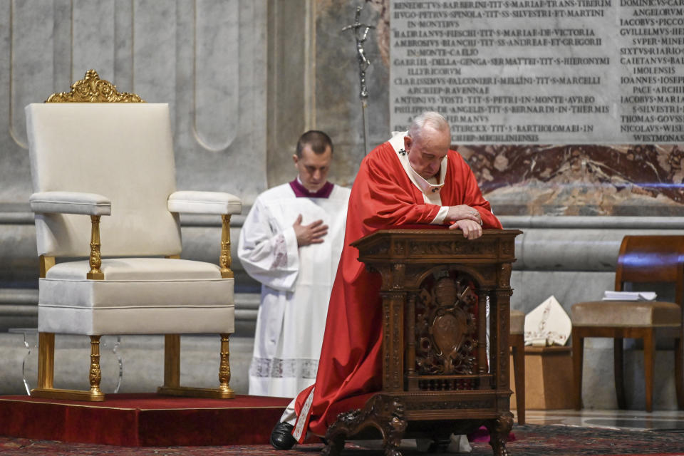 Pope Francis prays as he celebrates Palm Sunday Mass behind closed doors in St. Peter's Basilica, at the Vatican, Sunday, April 5, 2020, during the lockdown aimed at curbing the spread of the COVID-19 infection, caused by the novel coronavirus. (AP Photo/pool/Alberto Pizzoli)