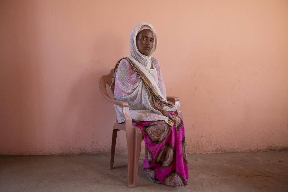 Tigrayan refugee Alem Mebrahtu, 30, who fled the conflict in Ethiopia's Tigray, sits for a portrait in eastern Sudan, near the border with Ethiopia, on March 15, 2021. Bodies were strewn near the riverbank, she said. "Some were face-down. Some were looking up at the sky." She estimated some 50 corpses. (AP Photo/Nariman El-Mofty)