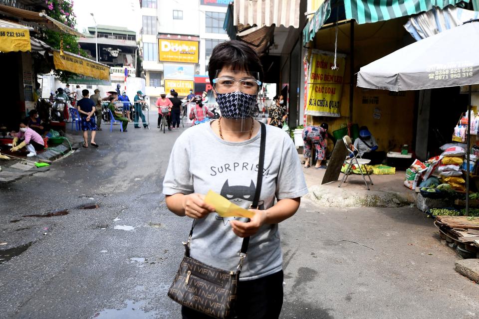 A woman carries a slip issued by Municipal authorities to visit wet-markets in Hanoi on July 29, 2021 amidst the government imposed two-week lockdown to stop the spread of the Covid-19 coronavirus. (Photo by NHAC NGUYEN / AFP) (Photo by NHAC NGUYEN/AFP via Getty Images)