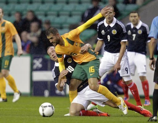 Charlie Adam (L) of Scotland vies with Australia's Carl Valeri (2nd L) during the international friendly football match at Easter Road Stadium in Edinburgh, Scotland. Scotland won 3-1 over Australia