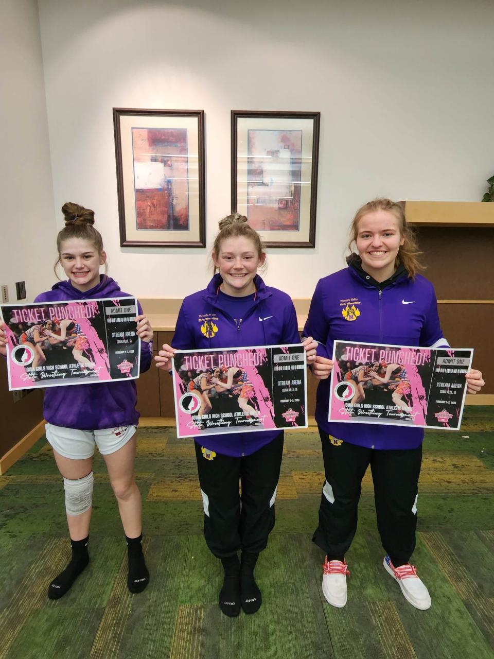 Nevada's Ashlyn Leslie (left), Gracie Leslie (center) and Mackenzie Arends all qualified for the girls state wrestling tournament following their performances at the Region 4 meet in Des Moines Friday.