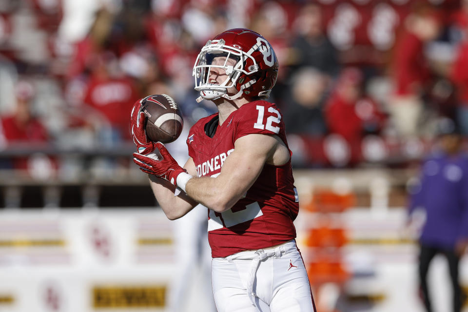 Oklahoma wide receiver Drake Stoops (12) warms up before an NCAA college football game against TCU Friday, Nov. 24, 2023, in Norman, Okla. (AP Photo/Alonzo Adams)