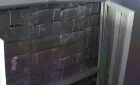 Police show a wall of money during a raid at the home belonging to Chinese businessman Zhenli Ye Gon in Mexico City, Mexico is seen in this still image taken from video, in March 2007. Mexican Attorney General/Handout via REUTERS