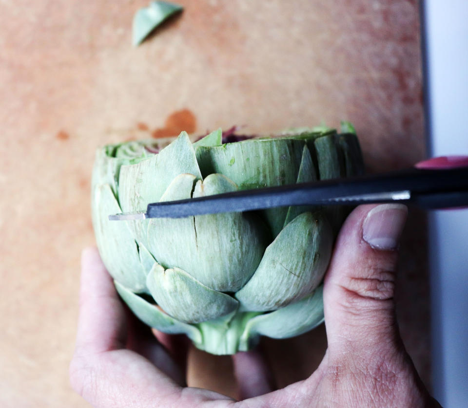 Cut the artichoke in half lengthwise. (Photo: Jeremy Paige)