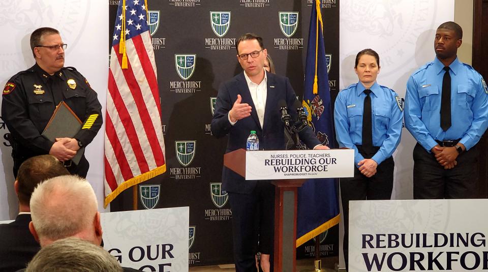 Gov. Josh Shapiro, center, discusses his plan to recruit more law enforcement officers as Erie Bureau of Police Chief Dan Spizarny, left, and cadets from the Mercyhurst Municipal Police Academy in North East, Pa. listen, on Thursday, March 23, 2023. 