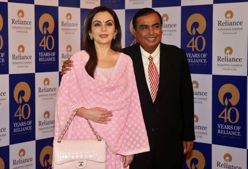 FILE PHOTO: Mukesh Ambani, Chairman and Managing Director of Reliance Industries, poses with wife Nita Ambani before addressing the company's annual general meeting in Mumbai