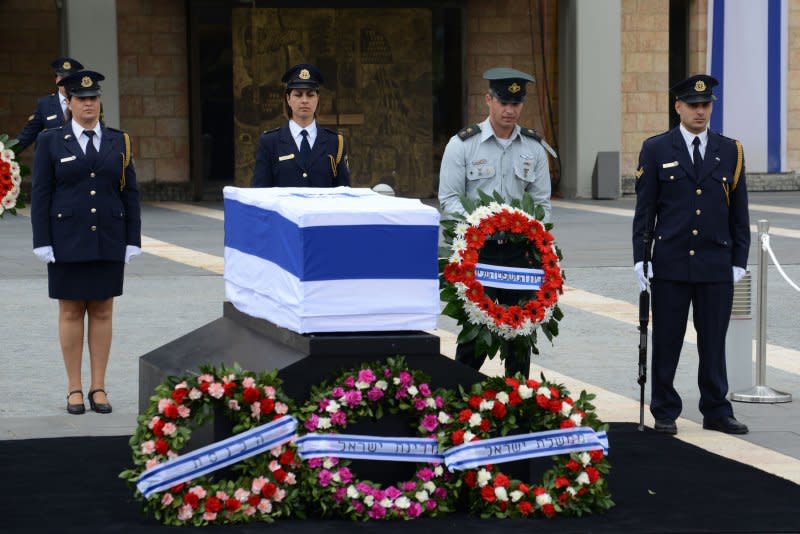 An Israeli defense officer carries a wreath beside the coffin of the late former Israeli Prime Minister Ariel Sharon in the Knesset Plaza, Israel's Parliament, in Jerusalem, Israel, on January 12, 2014. Sharon died January 11, 2014. File Photo by Debbie Hill/UPI