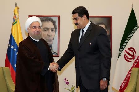 Venezuela's President Nicolas Maduro (R) shakes hands with Iranian President Hassan Rouhani in Porlamar, Venezuela September 16, 2016. Miraflores Palace/Handout via REUTERS