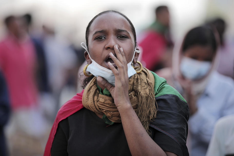 A woman chants slogans during a protest in Khartoum, Sudan, Saturday, Oct. 30, 2021. Pro-democracy groups called for mass protest marches across the country Saturday to press demands for re-instating a deposed transitional government and releasing senior political figures from detention. (AP Photo/Marwan Ali)