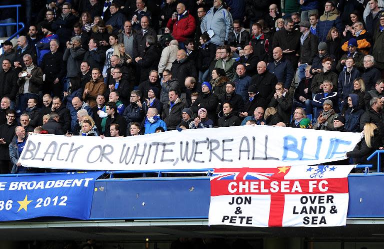 Chelsea fans hold an anti-racism banner during the English Premier League football match between Chelsea and Burnley at Stamford Bridge in London on February 21, 2015