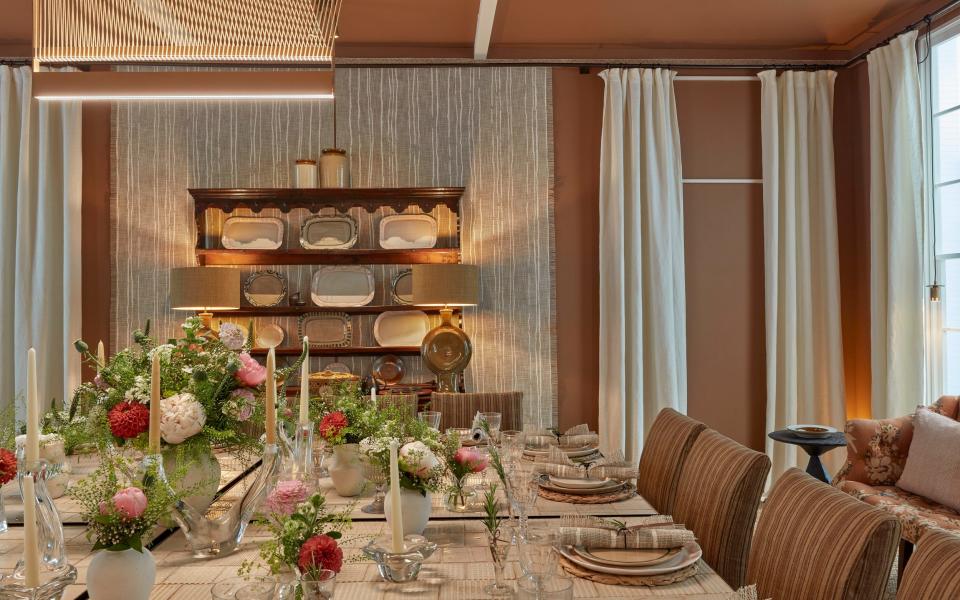 Crisp white-painted beams contrast with terracotta-brown paint on the ceiling of Martin Hulbert and Jay Grierson's dining room - James McDonald