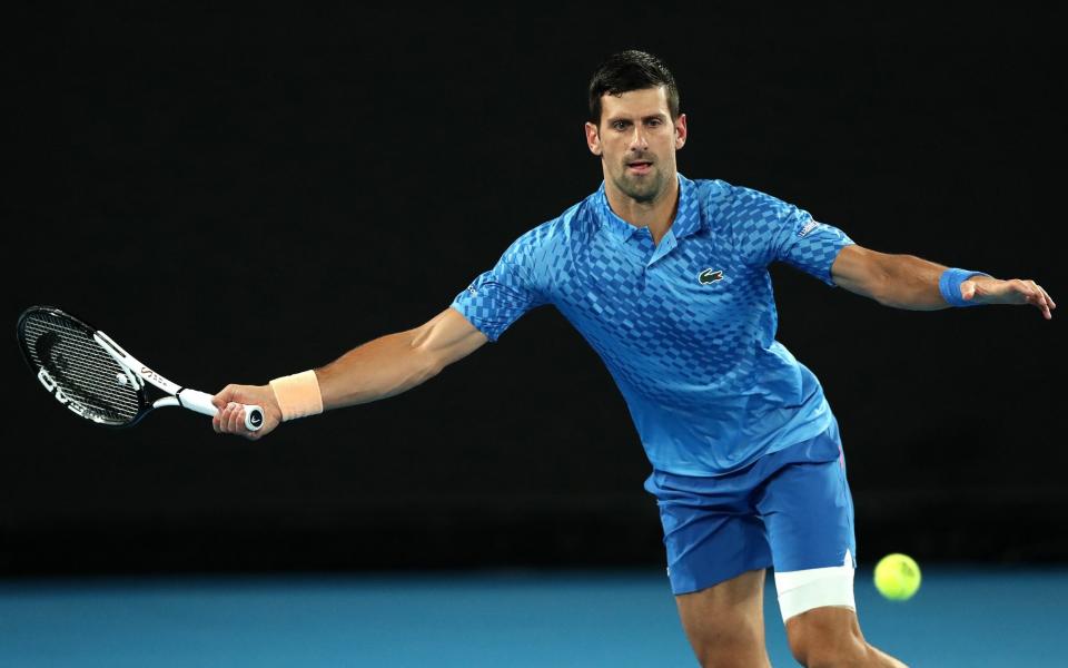 Novak Djokovic of Serbia plays a forehand in their round one singles match against Roberto Carballes Baena of Spain during day two of the 2023 Australian Open at Melbourne Park - Kelly Defina/Getty Images
