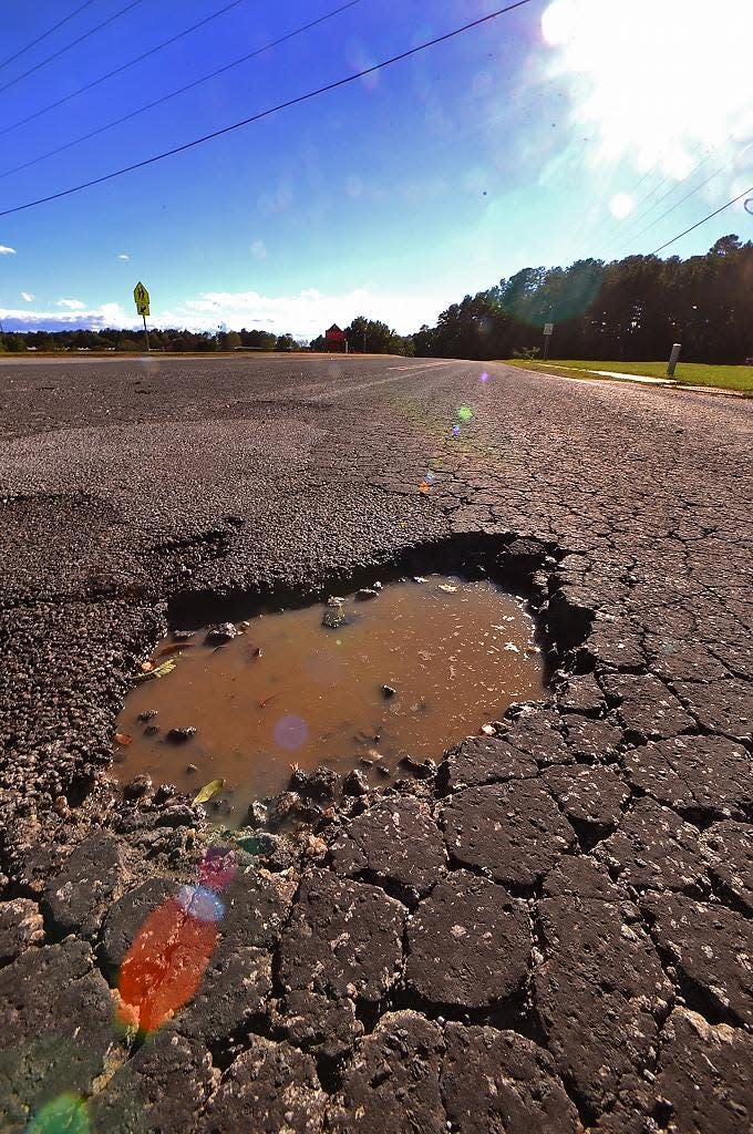 A pothole on Double Bridge Road between Highway 9 and Giles Heights Road in Boiling Springs. Spartanburg County Council is moving forward with a referendum that would let voters decide whether to approve a 1-cent sales tax for road, bridge and intersection improvements.
