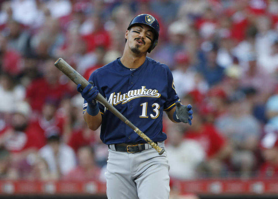 Milwaukee Brewers' Tyler Saladino (13) reacts to striking out against Cincinnati Reds starting pitcher Tyler Mahle during the third inning of a baseball game, Monday, July 1, 2019, in Cincinnati. (AP Photo/Gary Landers)