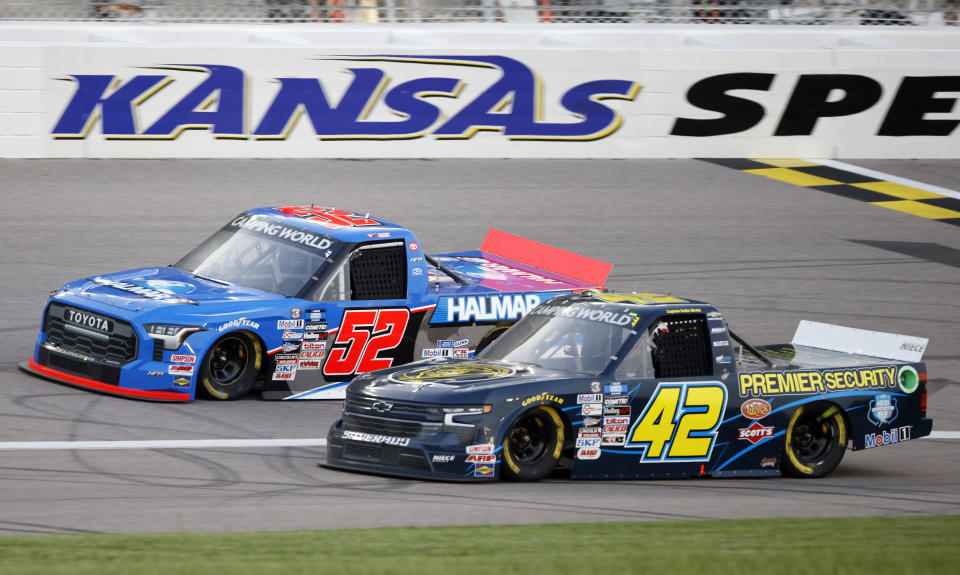 Stewart Friesen (52) and Carson Hocevar (42) head down the front straightaway during a NASCAR Truck Series auto race at Kansas Speedway in Kansas City, Kan., Saturday, May 14, 2022. (AP Photo/Colin E. Braley)