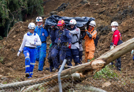 Rescuers carry the body of one of the victims of a landslide that affected the Medellin-Bogota highway in Colombia October 26, 2016. Courtesy of EL Colombiano Newspaper/Handout via Reuters. ATTENTION EDITORS - THIS IMAGE WAS PROVIDED BY A THIRD PARTY. FOR EDITORIAL USE ONLY. NO RESALES. NO ARCHIVES.
