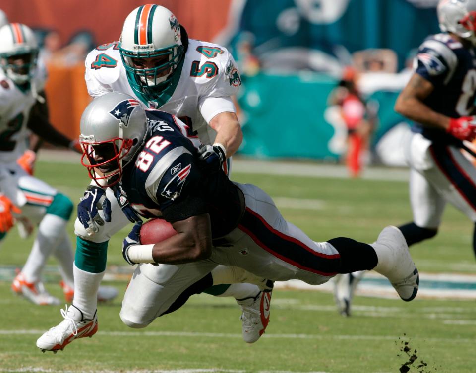 FILE - New England Patriots tight end Daniel Graham (82) is stopped by Miami Dolphins linebacker Zach Thomas (54) in the first quarter during an NFL football game in Miami, in this Sunday, Dec. 10, 2006, file photo. Zach Thomas is a 2021 finalist for entry into the Pro Football Hall of Fame. (AP Photo/Lynne Sladky, File)