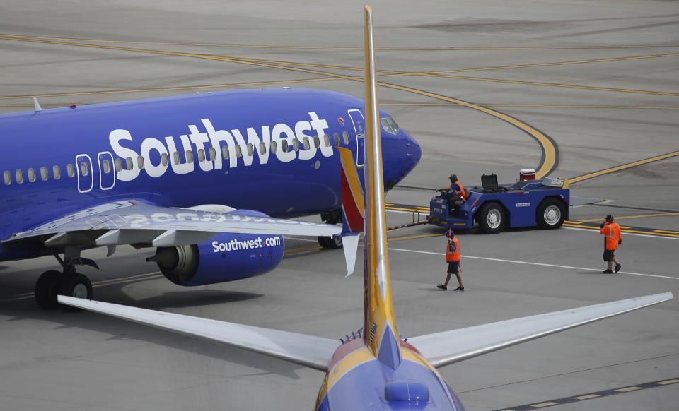 This Wednesday, July 17, 2019 photo shows Southwest Airlines planes at Phoenix Sky Harbor International Airport in Phoenix. Southwest Airlines Co. reports earnings Thursday, July 25. (AP Photo/Ross D. Franklin)