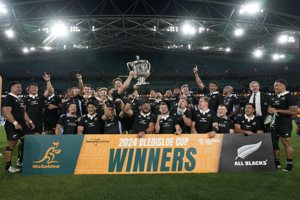 New Zealand celebrate with the bLedisloe Cup after their win over Australia in rugby union test match in Sydney, Saturday, Sept. 21, 2024. (AP Photo/Rick Rycroft)