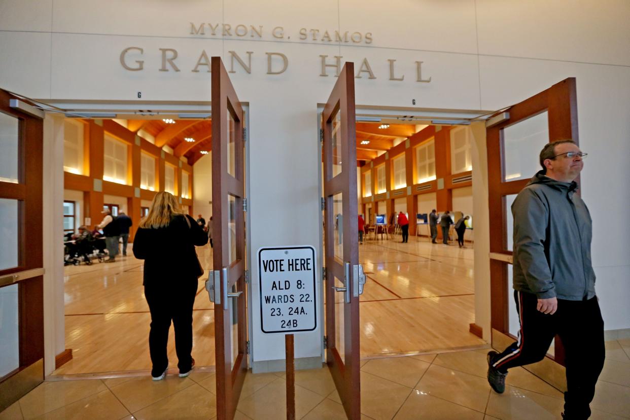 Voters enter and leave the James W. Pihos Cultural Center in Wauwatosa on Tuesday, April 4, 2023 .