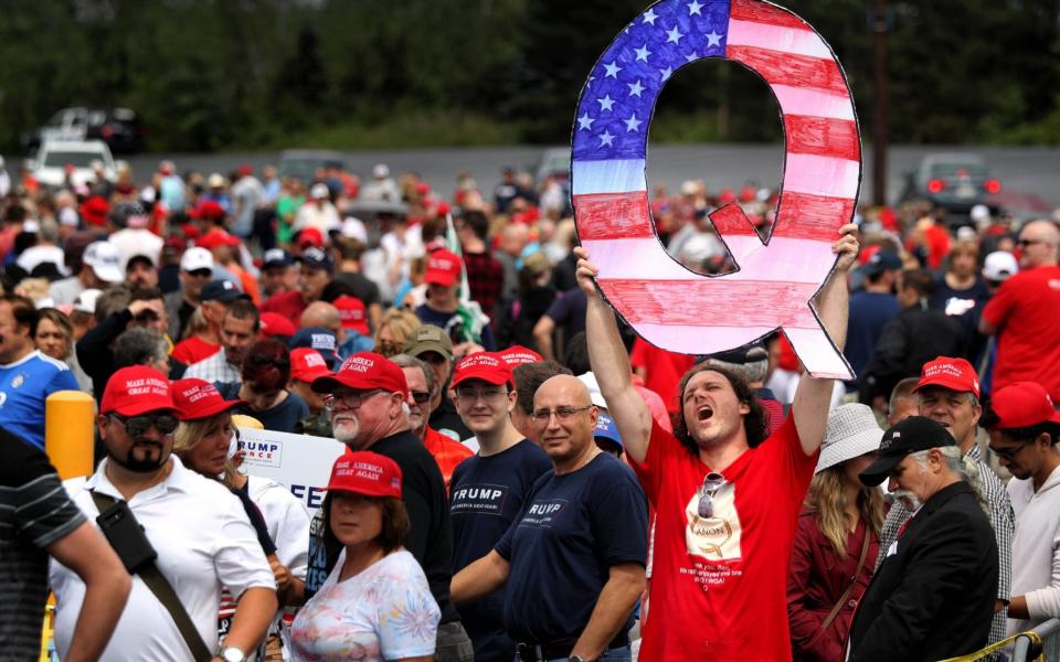 A QAnon support attends a Trump rally in 2018 - Getty