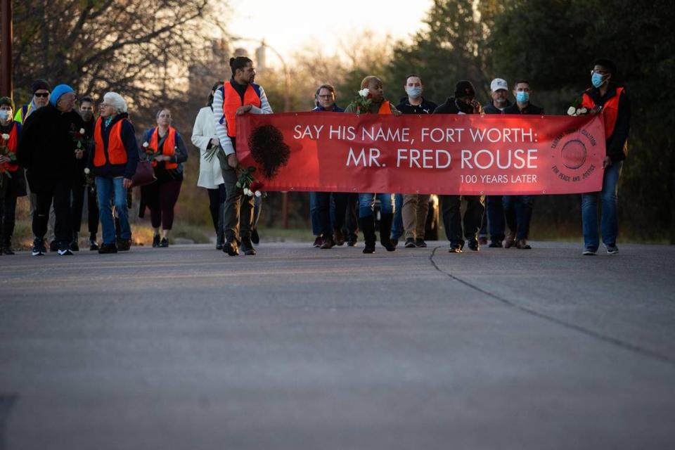 A group walks during a vigil to remember 100 years after the attack on Fred Rouse Dec., 6, 2021, at the Fort Worth Stockyards. Rouse was later abducted from a hospital and lynched on Dec. 11, 1921.