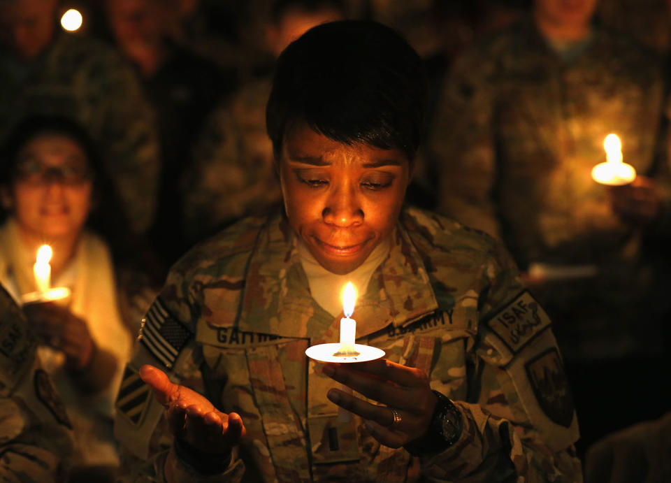 <p>U.S. troops from the Nato-led International Security Assistance Force (ISAF) light candles during Christmas Eve celebrations at Bagram Airfield, north of Kabul, Dec. 24, 2014. (Photo: Mohammad Ismail/Reuters) </p>