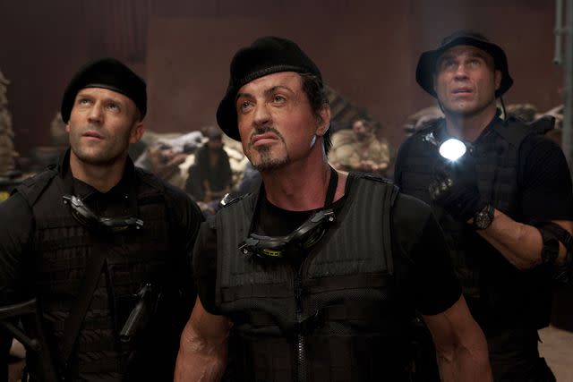 <p>Milennium/Kobal/Shutterstock</p> Jason Statham, Sylvester Stallone and Randy Couture in 'The Expendables,' 2010
