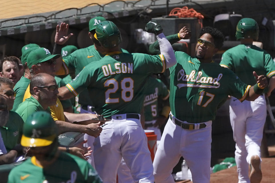 Oakland Athletics' Matt Olson (28) is congratulated by Elvis Andrus (17) after hitting a home run against the Kansas City Royals during the fifth inning of a baseball game in Oakland, Calif., Sunday, June 13, 2021. (AP Photo/Jeff Chiu)