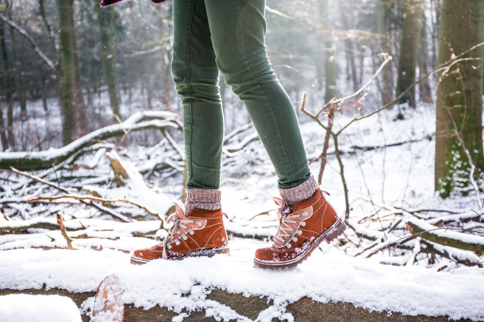 A woman hiking in the forest at the snowstorm