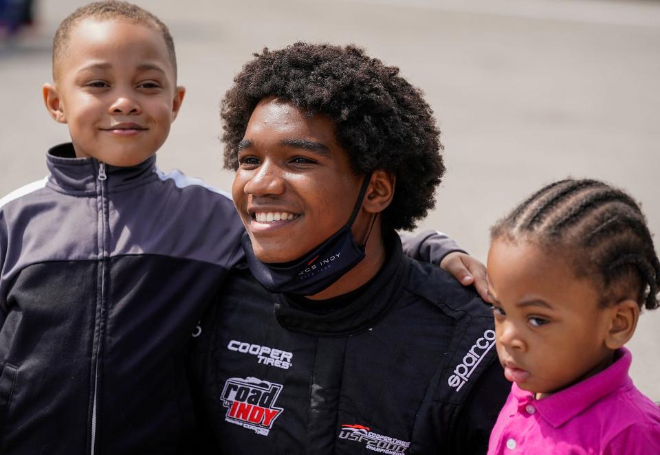 USF2000 driver Myles Rowe poses for a photo with young fans last season at the Indianapolis Motor Speedway.