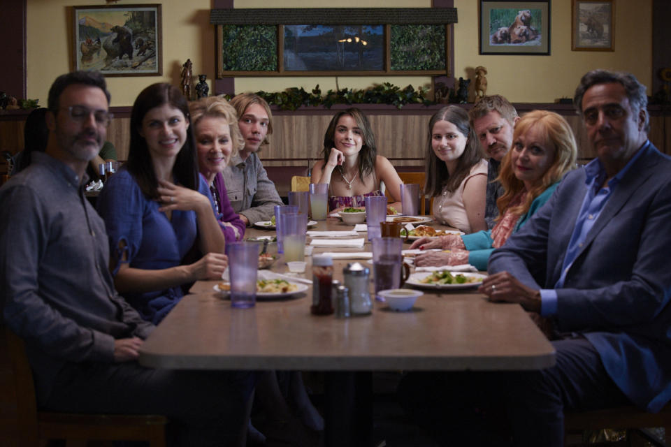 family looking at the camera from the dinner table