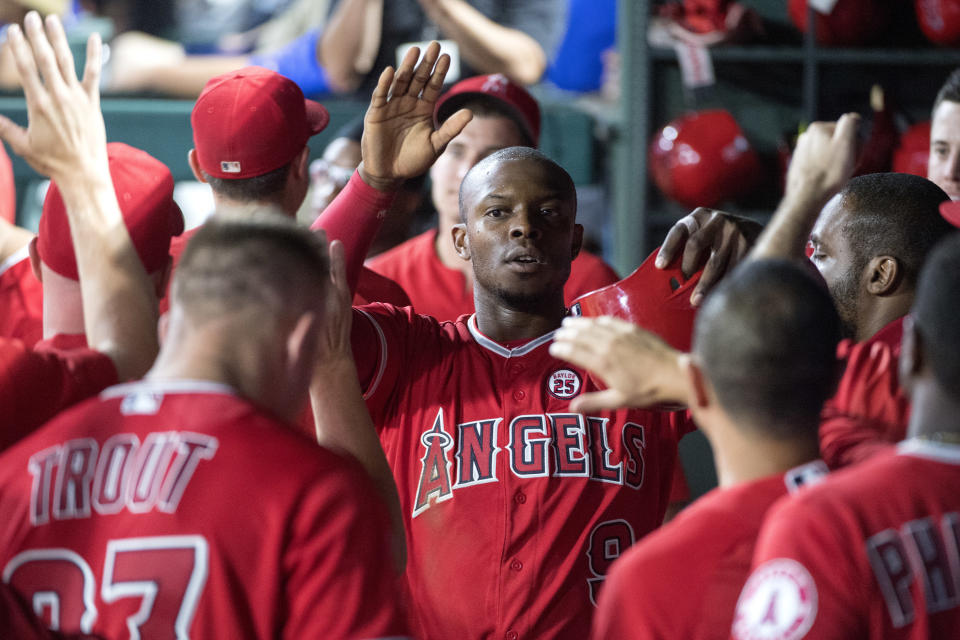 Justin Upton (center) will stay with the Angels for the next five seasons after agreeing to a new contract. (AP)