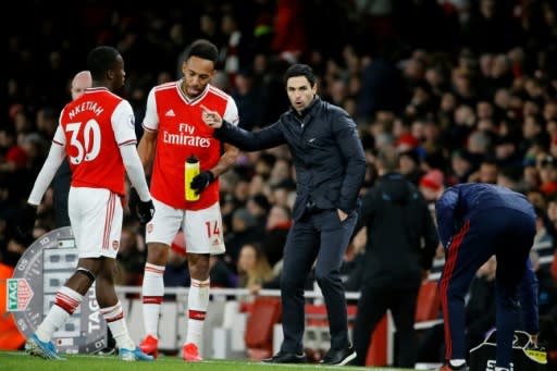 Pierre-Emerick Aubameyang (C) listens to Arsenal manager Mikel Arteta during the victory over Everton