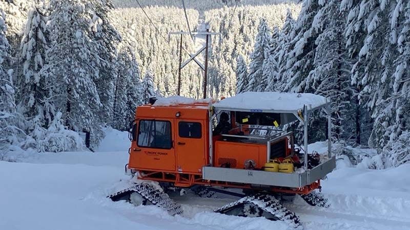 A snowcat carries utility crews in southern Oregon.