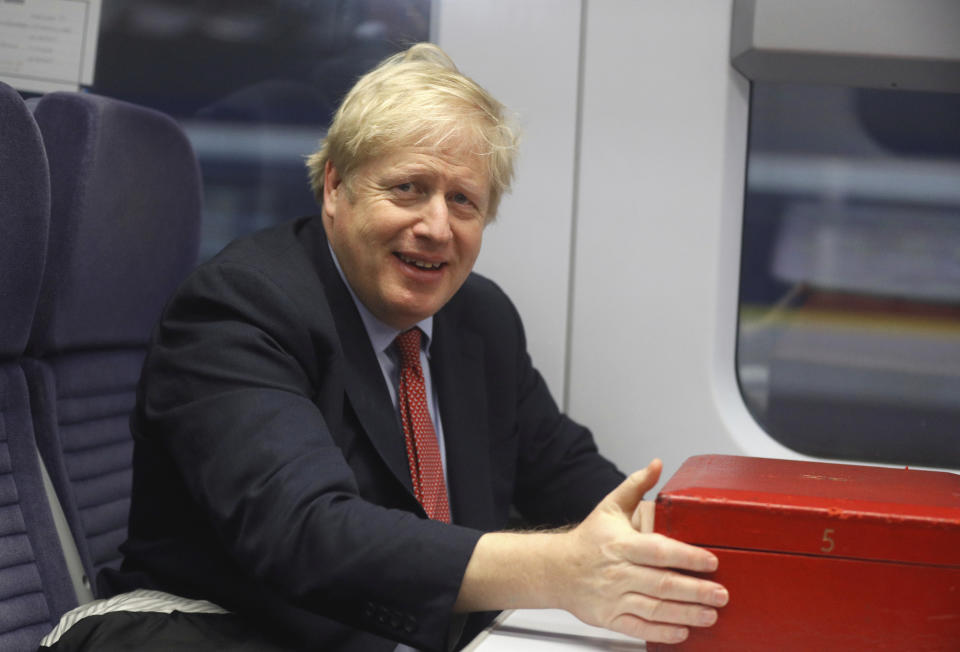 Britain's Prime Minister Boris Johnson sits on a train in London, Friday Dec. 6, 2019, on the campaign trail ahead of the general election on Dec. 12. Johnson pushed for the December vote, which is taking place more than two years early, in hopes of winning a majority and breaking Britain's political impasse over Brexit. (Peter Nicholls/Pool via AP)