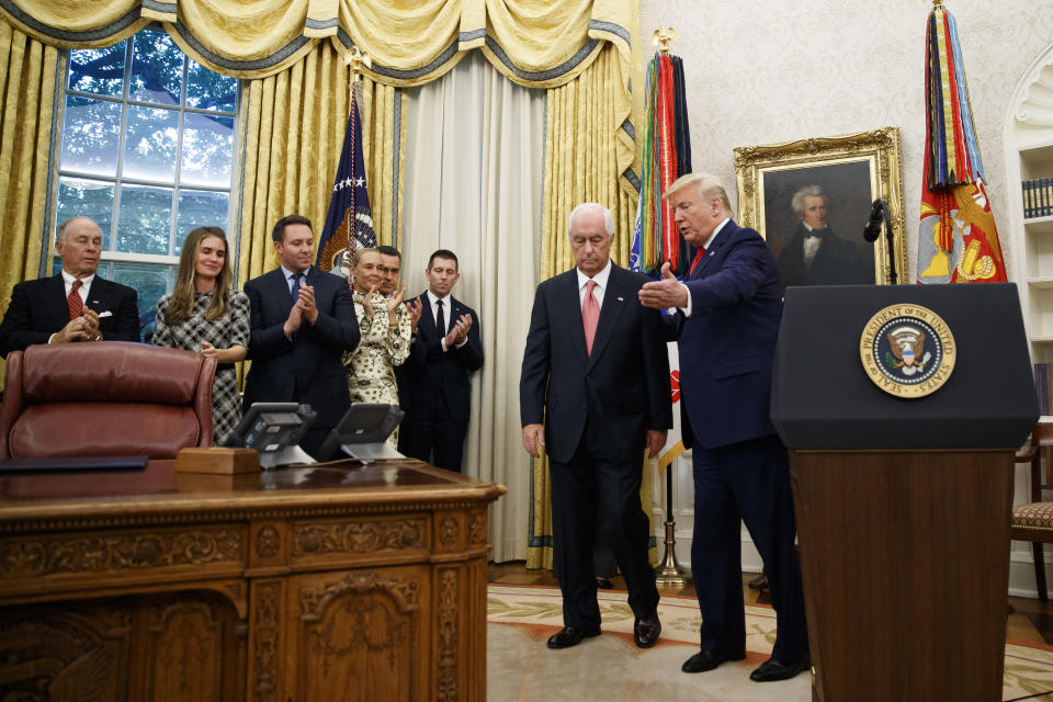 President Donald Trump directs auto racing great Roger Penske, during a Presidential Medal of Freedom ceremony in the Oval Office of the White House, Thursday, Oct. 24, 2019, in Washington. (AP Photo/Alex Brandon)